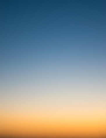 Sunset sky with blue and golden orange colors at dusk background