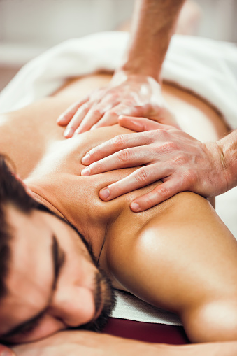 Young man is having massage on spa treatment.