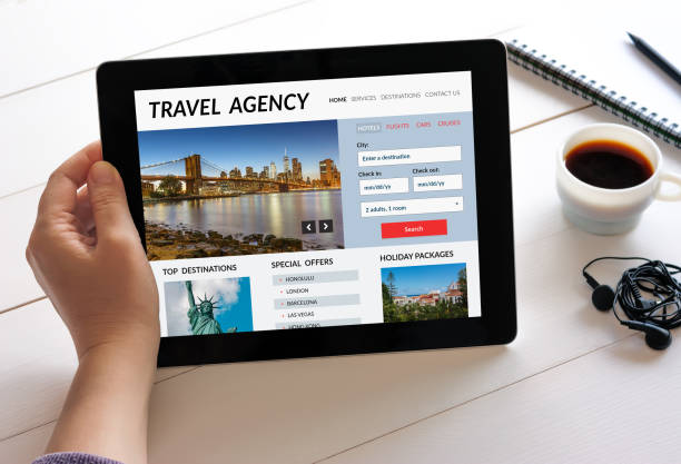 istock Hand holding tablet with travel agency concept on screen 907947916