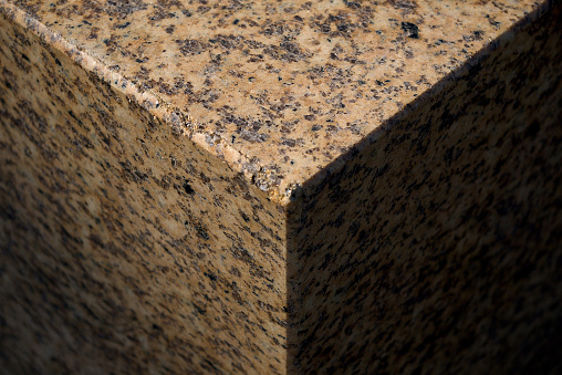 polished granite cube part in natural sunlight