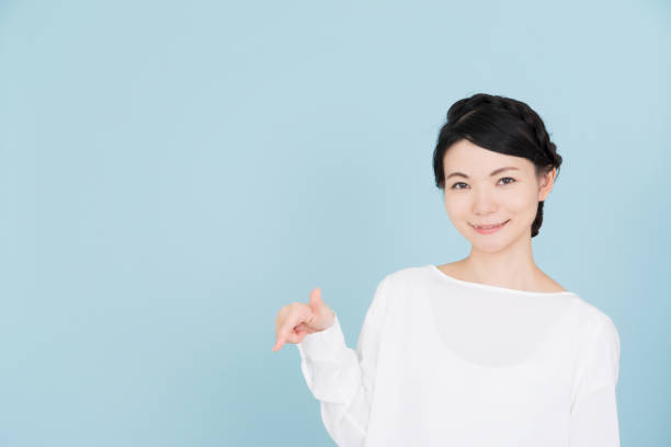 istock Young woman pointing to the copy space 907950784