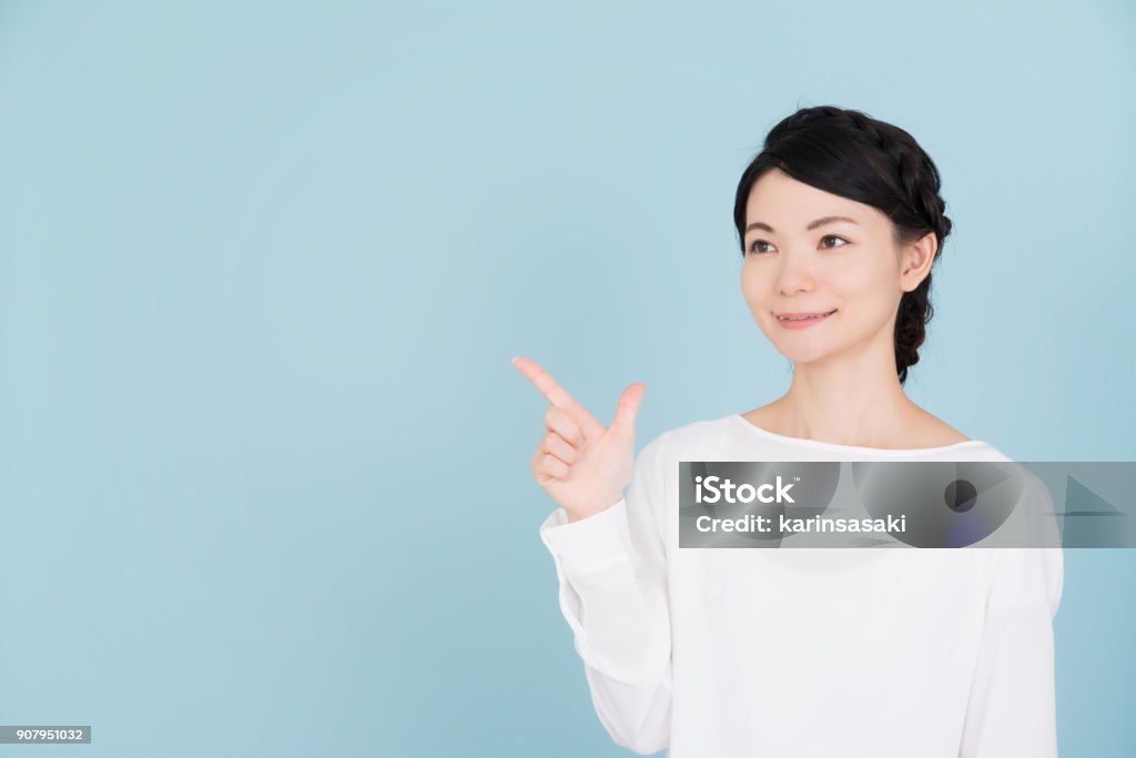 Young woman pointing to the copy space Women Stock Photo
