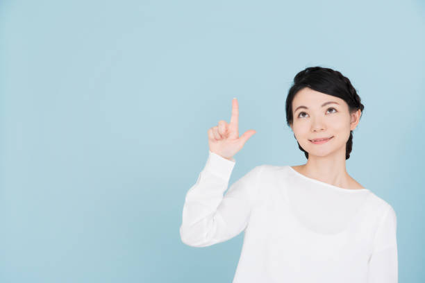 istock Young woman pointing to the copy space 907951100