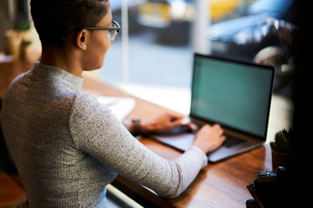 istock Rear view of professional afro american web designer working on freelance using wifi connection in cafe for modeling project in application, back view of busy copywriter creating advertising text 907952180