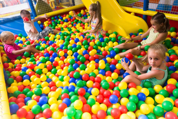 istock children playing together in pool with plastic multicolored balls 907952844