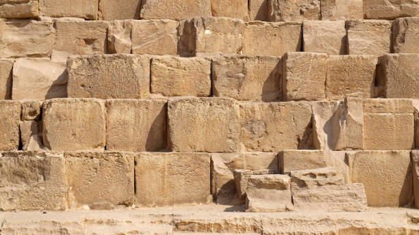 Giza GIZA CAIRO EGYPT - OCTOBER 2009:  Pyramid of Khafre detail brick on the wall closeup background. pyramid giza pyramids close up egypt stock pictures, royalty-free photos & images