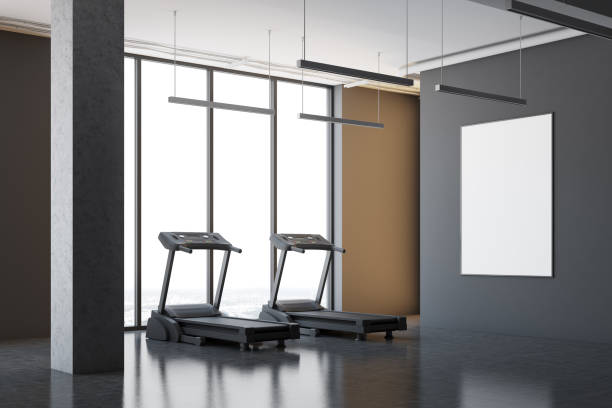 istock Two treadmills in a gray room corner, poster 907954576
