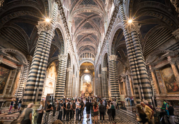 Siena, Italy - Crowds of visitors inside Duomo di Siena, a structure that was built in medieval times, and has been developed in many stages since.