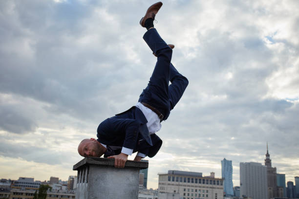 istock Young businessman's rooftop training. Vitality and fun 907956064