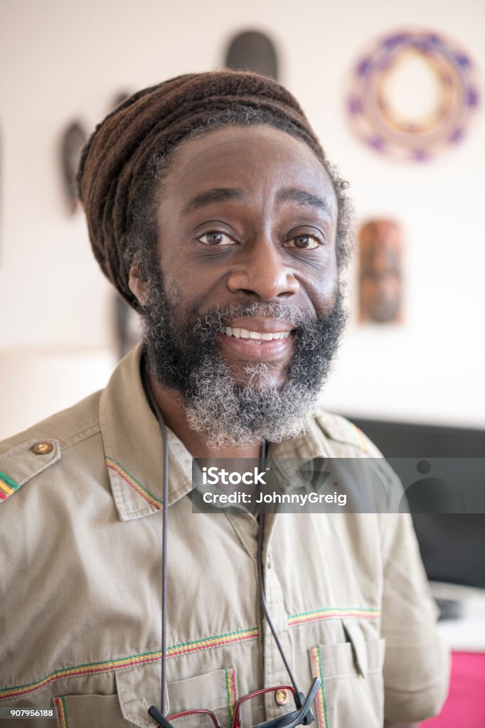 Cheerful African Man In His 50s With Beard Looking At Camera And Smiling  Stock Photo - Download Image Now - iStock