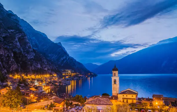 Beautiful view over the famous town of Limone sul Garda and the dramatic mountains of the north western coast of Lake Garda on a beautiful spring morning at 5 am.