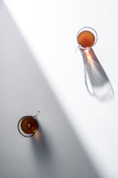 istock top view of two glass cups with tea on table with shadow 907957744
