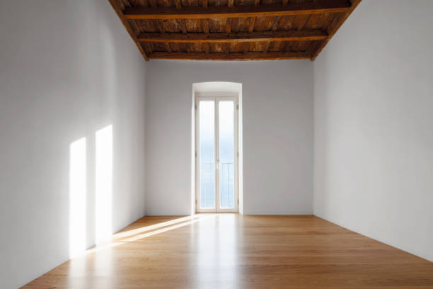 istock Empty room with large windows and antique beams 907958266