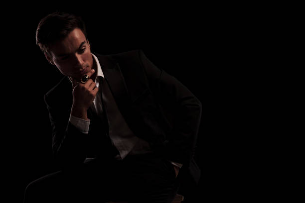 istock man in tuxedo wearing big ring in thinking 907959610