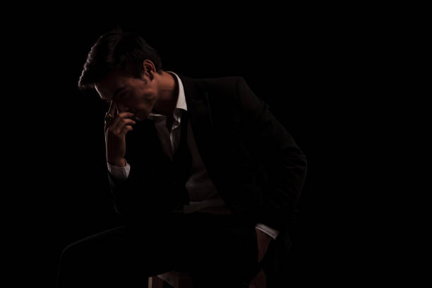 istock side view of seated thoughtful man in tuxedo 907959658