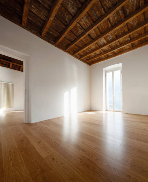 istock Empty room with large windows and antique beams 907960012