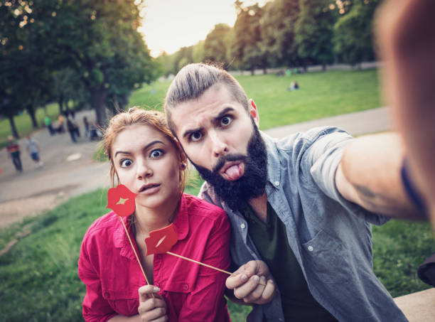 istock Teenagers making selfies with red paper lips 907963166