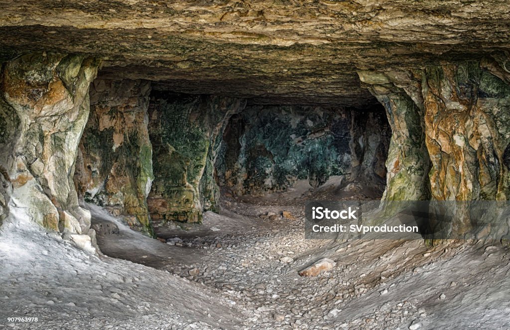 Abandoned limestone tunnels Inside the corridors of old abandoned limestone mines. Cave Stock Photo