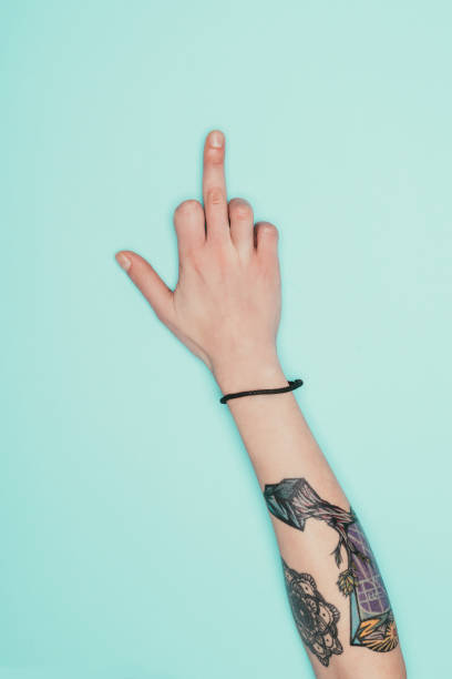 istock woman showing middle finger isolated on turquoise 907966408
