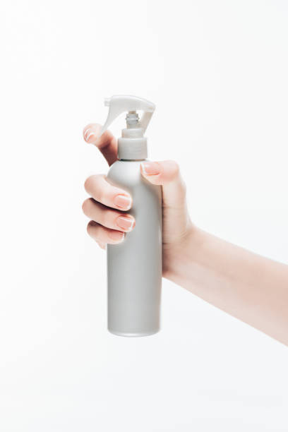 istock woman holding blank cosmetic spray bottle isolated on white 907967218