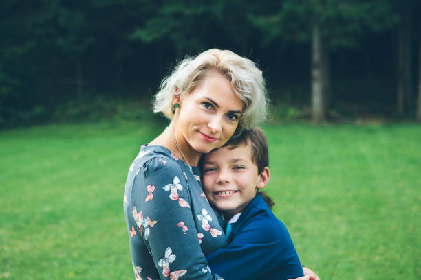 Close-up of a mother and son hug. stock photo