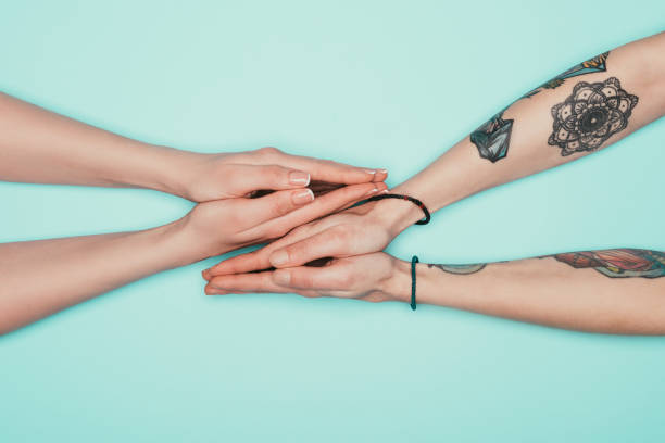 istock women making prayer gestures isolated on turquoise 907969582
