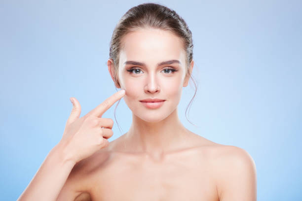 istock Beautiful woman pointing at cheek 907971780