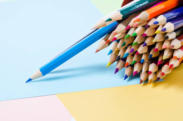 istock pencils on color paper. 907973098