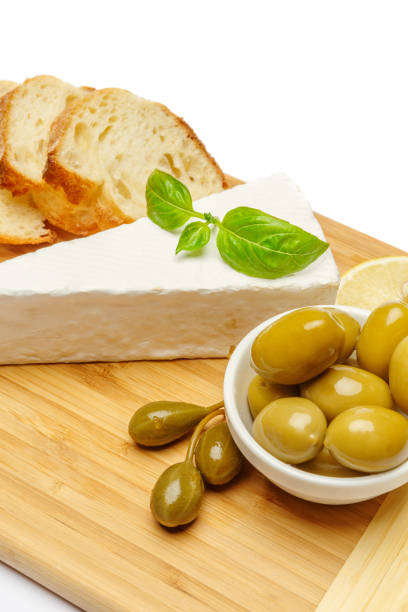 Close up of unrecognizable person taking cheese from a plate.
