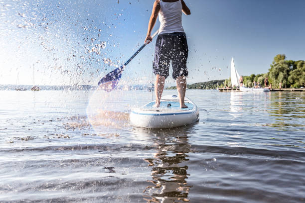 istock Low Section Of Man Paddleboarding On Sea 907975094