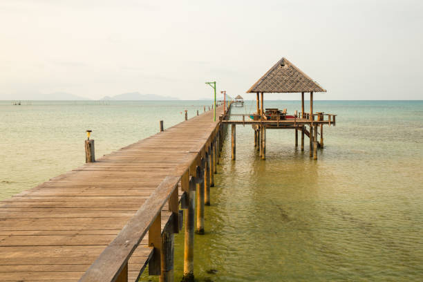 istock Pier By Gazebo Over Sea Against Sky 907977858