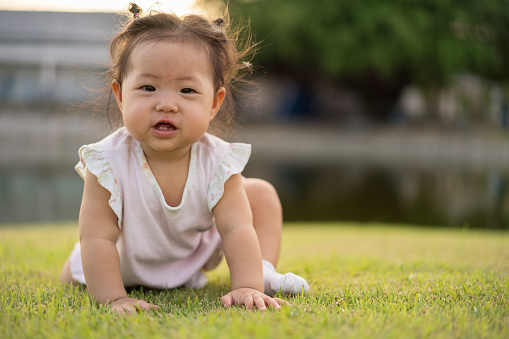 Asian little girl in the park, Happy smile.