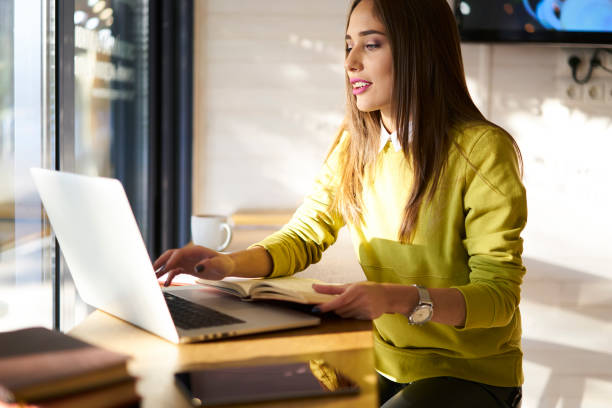 istock Attractive administrative manager using laptop computer for work creating report of incomes, beautiful young student pondering on homework task analyzing information from network and textbooks 907984948