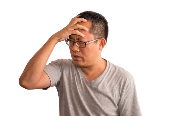 istock Asian man having a headache on isolated background 907985348