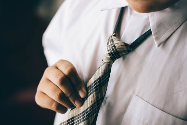 istock Midsection Of Man Holding Necktie 907990706