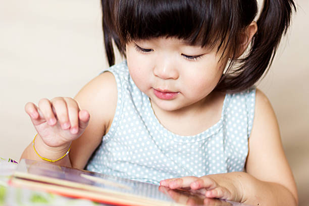 istock Preschool lovely asian child playing tablet happily 907991502