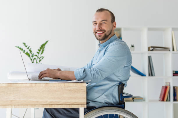 istock hadicapped businessman with laptop 907991960