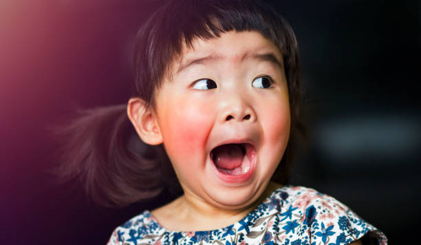 A little lovely asian girl feels shocked and open mouth wide stock photo
