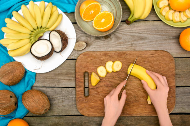person slicing banana