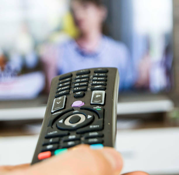 istock watching TV and changing the channels with the control, changing the TV channels with the control watching television is a rather harmful activity for children and babies. 907998384