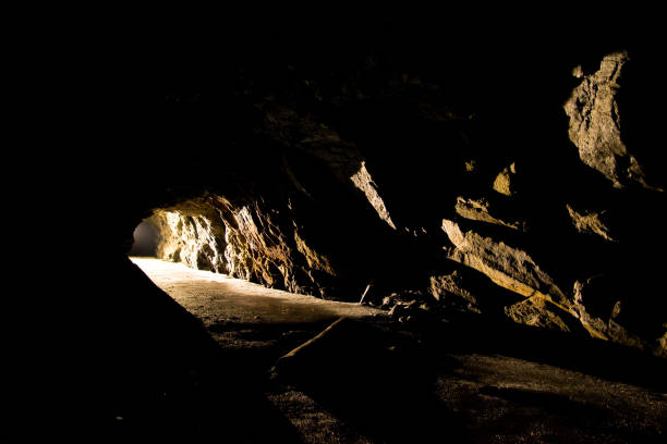 istock Light in tunnel in abandoned mine 907998802