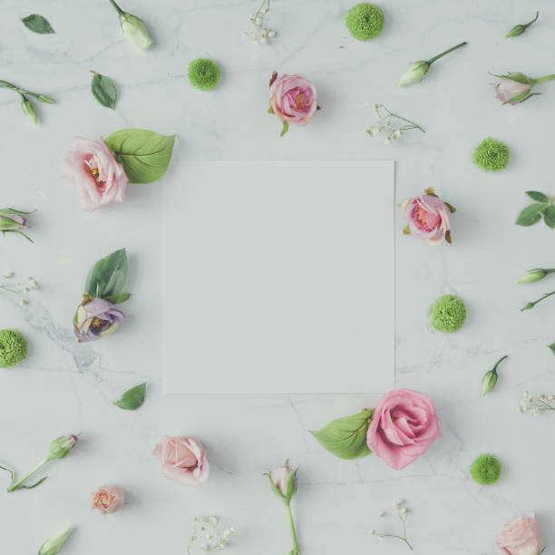 istock Creative natural pattern made of flowers and leaves on marble background. Flat lay composition. 908001432