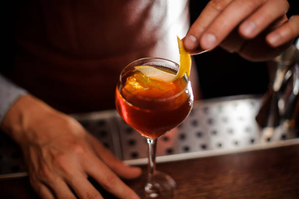 istock Bartender is decorating a cocktail with lemon zest 908001456