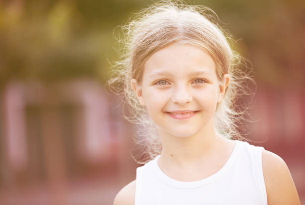 istock girl smiling outdoors 908001920