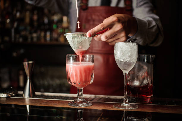 istock Barman is making alcoholic cocktail at the bar 908002040