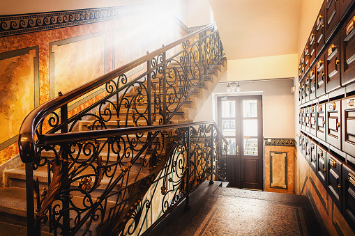 classic and elegant stairs in hallway with sunlights througn window. building interior of european style in resident house