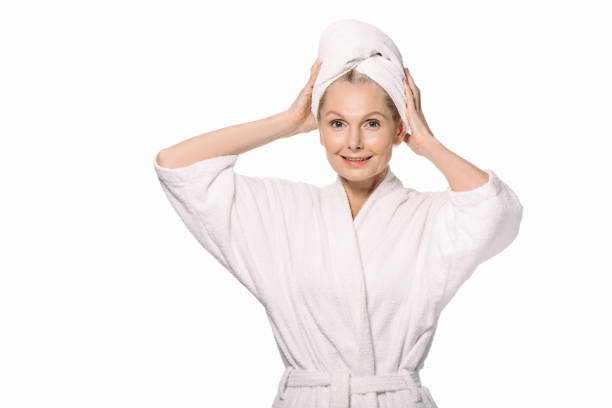 istock middle aged woman in bath robe 908004818