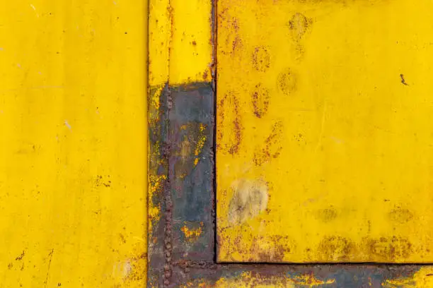 Metal background of yellow color, metal connections for welding. Copy space