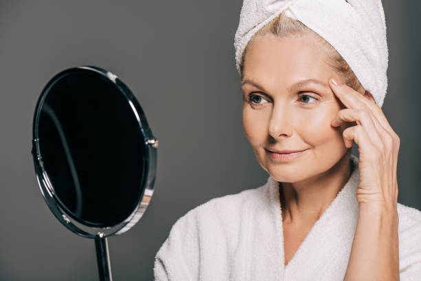 istock mature woman in bath robe 908005276