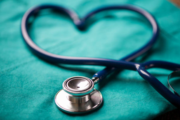 istock A stethoscope shaping a heart on a medical uniform, closeup 908006016